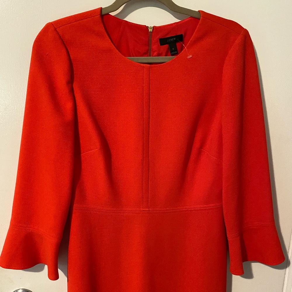Beautiful tailored and feminine orange dress with slight bell sleeves